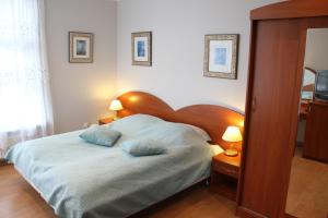 a bedroom with a bed with two pillows on it at Villa Aqua in Międzyzdroje