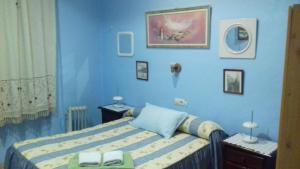 Dormitorio azul con cama y pared azul en la castanuela albayzin, en Granada