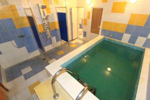 a bathroom with a large pool of water at Ukraina Hotel in Simferopol