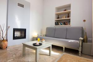 a living room with a couch and a table at Madena Apartments in Stoupa