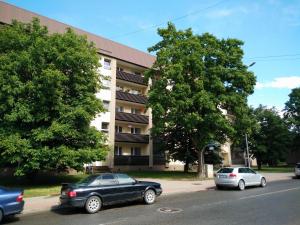 a black car parked in front of a building at Kaktuss Apartamenti in Valmiera