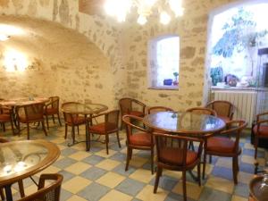a room with tables and chairs in a restaurant at A La Porte Saint Jean in La Souterraine
