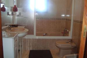a bathroom with a sink and a toilet and a tub at Casa do Nascente in Paredes do Rio +35 photos