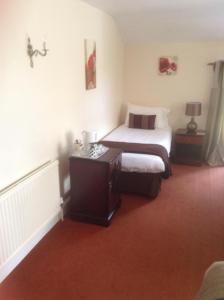 A bed or beds in a room at Bridgefoot Guest House 