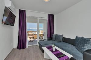 a living room with a couch and a table at Apartmani Daniela Podgora in Podgora