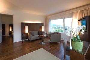 a living room with a couch and a table at Hotel Penz West in Innsbruck