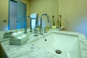 a bathroom with a sink and two faucets at Hotel Penz West in Innsbruck