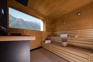 a room with a wooden bench and a large window at Hotel Penz West in Innsbruck
