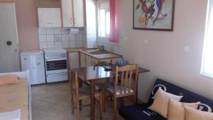 a small kitchen with a table and a table and chairs at Chris Apartment in Preveza