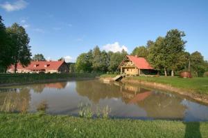 a house next to a river with a house at Lobes Krogs in Gobas