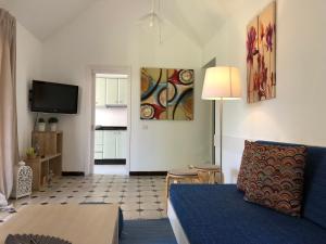 a living room with a bed and a tv at TC Bungalow Melocotones 15 in Maspalomas +15 photos