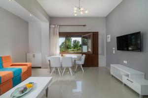 a living room with a couch and a table at Luxury apartments Marianna in Neos Marmaras