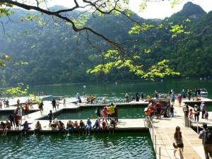 a group of people on a dock in a lake at Seri Lagenda Apartment in Kuah
