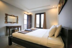 Ein Bett oder Betten in einem Zimmer der Unterkunft Nyoman Villa Sanur