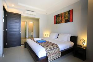 Ein Bett oder Betten in einem Zimmer der Unterkunft Nyoman Villa Sanur