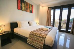 Ein Bett oder Betten in einem Zimmer der Unterkunft Nyoman Villa Sanur