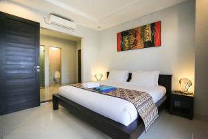Ein Bett oder Betten in einem Zimmer der Unterkunft Nyoman Villa Sanur