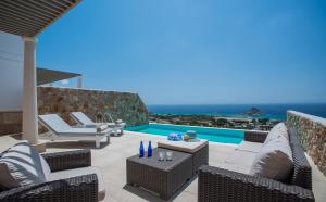 a patio with chairs and a swimming pool at White Rock of Kos Hotel - Adults only in Kefalos