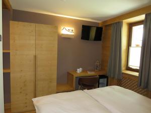Postel nebo postele na pokoji v ubytování Hotel Compagnoni