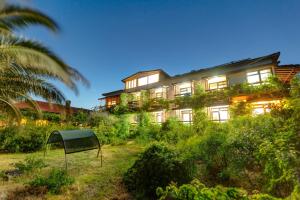 a large building with plants on the side of it at Assos Terrace Hotel in Behramkale