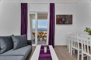 a living room with a couch and a table at Apartmani Daniela Podgora in Podgora