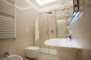 a bathroom with a sink and a toilet and a shower at Albergo del Golfo in Naples