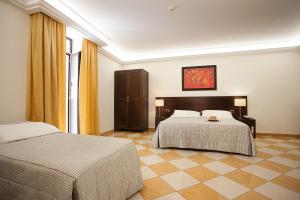 a hotel room with two beds in a room at Albergo del Golfo in Naples +41 photos