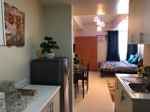 a kitchen and a living room with a refrigerator in a kitchen at Centropolis in Manila