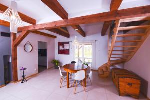 a dining room with a table and a staircase at Apartament Topczewo in Topczewo