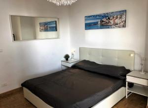 a bedroom with a large bed and a mirror at House Levante by Holiday World in Pieve Ligure