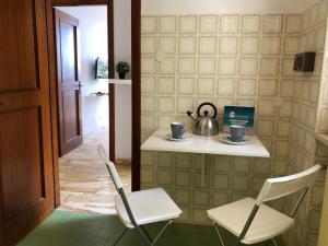 a room with two chairs and a table with a tea kettle at House Levante by Holiday World in Pieve Ligure