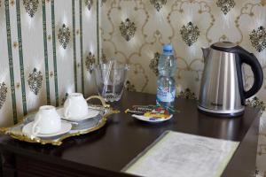 a table with a tea set and a bottle of water at Garden Hall in Ternopil