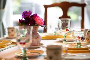 un tavolo con un vaso con fiori viola di TwiningRetreat a Niagara on the Lake