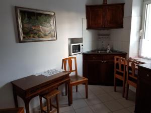 a kitchen with a table and chairs and a sink at Santino Apartment in Sibiu