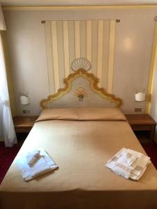 Posteľ alebo postele v izbe v ubytovaní Hotel Posta R.T.A.