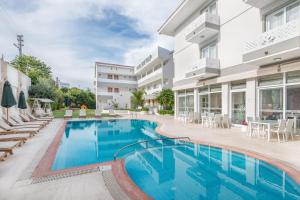 a swimming pool in front of a building at Ege Tulip Cesme in Cesme