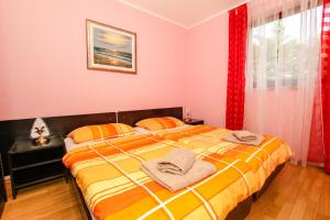 Ein Bett oder Betten in einem Zimmer der Unterkunft Guest House Katarina