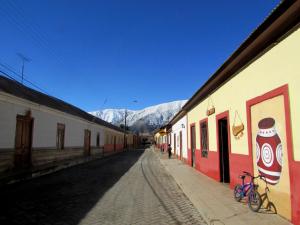 an empty street with a coke sign on a building at Elqui Sol in Vicuña