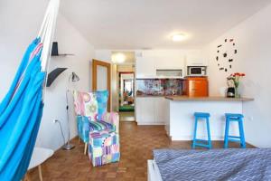 a room with a kitchen and a living room at Apartment Living Colors in Ljubljana