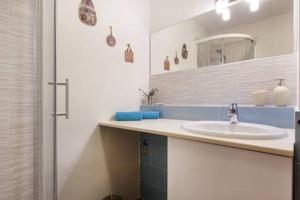 a bathroom with a sink and a mirror at Apartment Living Colors in Ljubljana