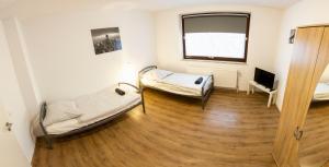 a room with two beds and a television in it at AVR Apartment HOF 1 in Bremerhaven