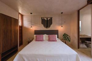 a bedroom with a bed and a dresser at Colonte Hotel Origen in Valladolid