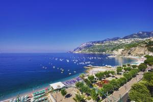 a view of a beach with boats in the water at Residenza Sole Maiori in Maiori
