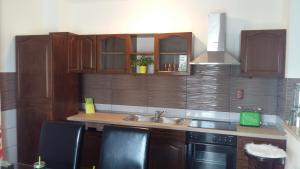 a kitchen with wooden cabinets and a sink at apartman Marina in Sutivan