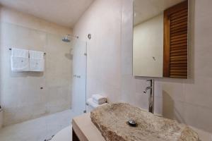 a bathroom with a sink, toilet and shower stall at Colonte Hotel Origen in Valladolid