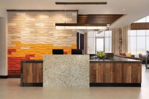 an office lobby with a stone wall and a reception desk at Hyatt Place Page Lake Powell in Page