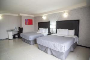 Een bed of bedden in een kamer bij Hotel Ha