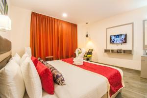 Ένα ή περισσότερα κρεβάτια σε δωμάτιο στο Mantris Hotel