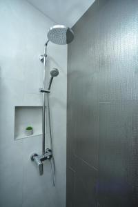 a shower with a shower head in a bathroom at Apartments 110 in Budva in Budva