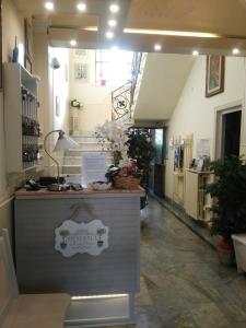 a shop with a counter in a hallway with stairs at Hotel Ondina in Viareggio